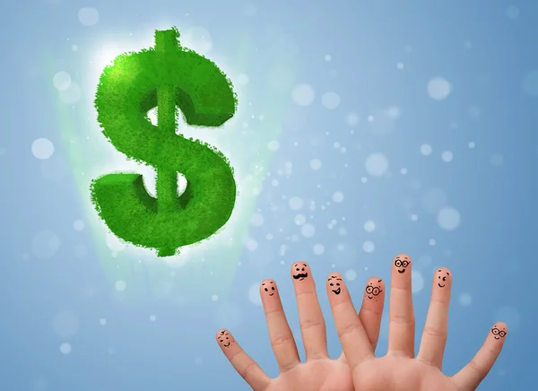 Happy smiley fingers looking at green leaf dollar sign — Stock Photo, Image