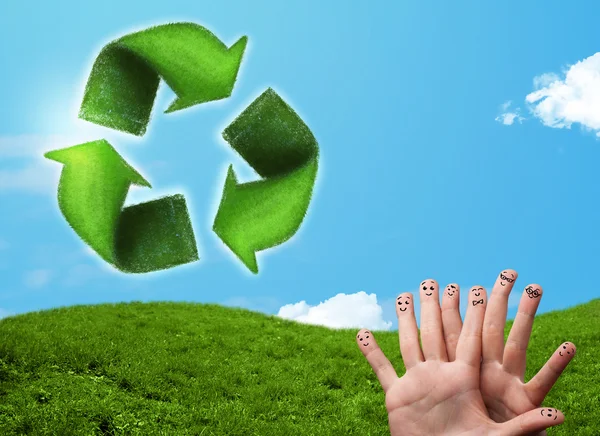 Happy smiley fingers looking at green leaf recycle sign — Stock Photo, Image