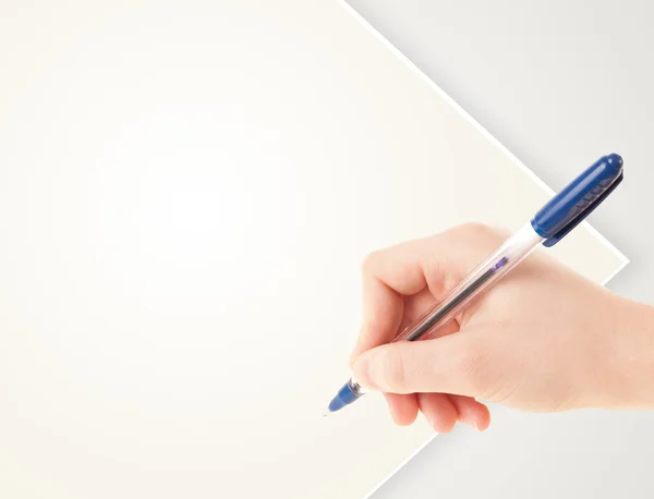 Hand writing on plain empty white paper copy space — Stock Photo, Image