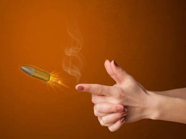 Gun shaped woman hand with bullet — Stock Photo, Image