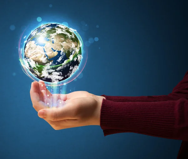 Woman holding a glowing earth globe — Stock Photo, Image