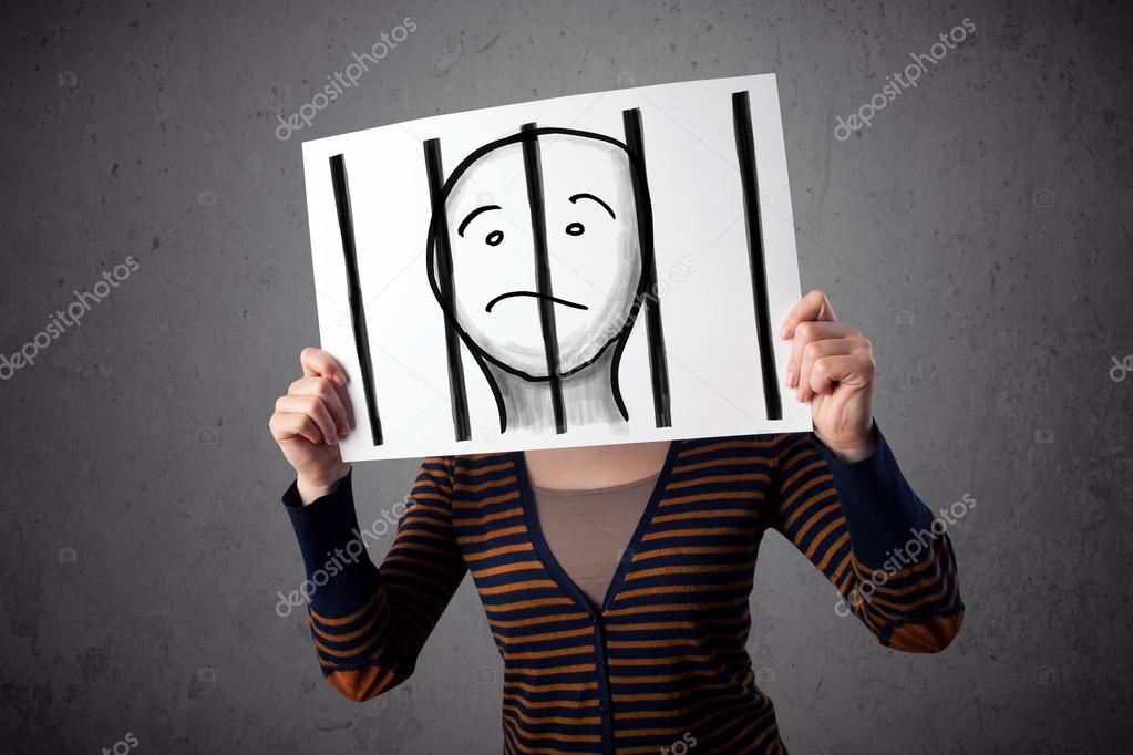 Woman holding a paper with a prisoner behind the bars on it in f