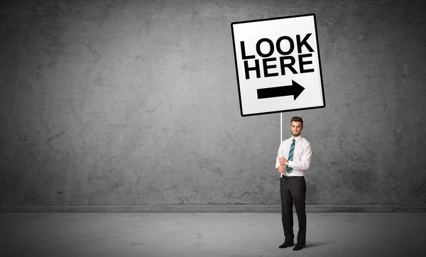 Business person holding a traffic sign — Stock Photo, Image