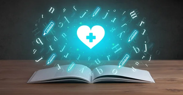 Open medical book with health icons above — Stock Photo, Image