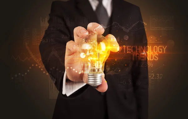 Businessman holding a lightbulb concept — Stockfoto