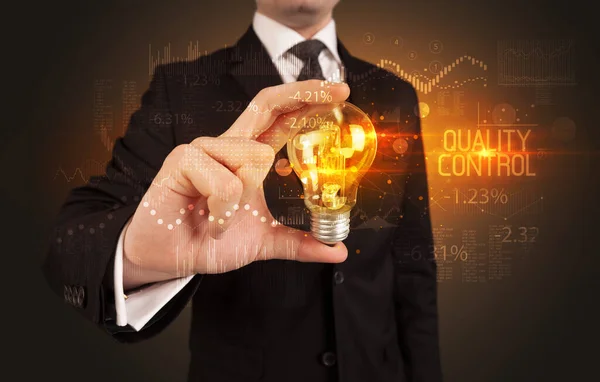Businessman holding a lightbulb concept — Stock Fotó