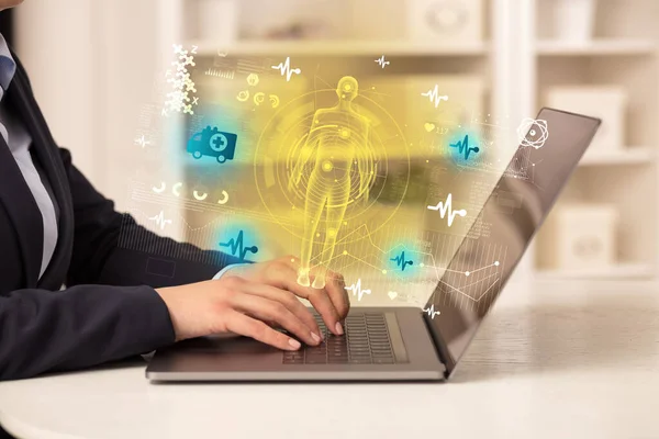 Doctor working on laptop with healthcare concept — Stock Photo, Image