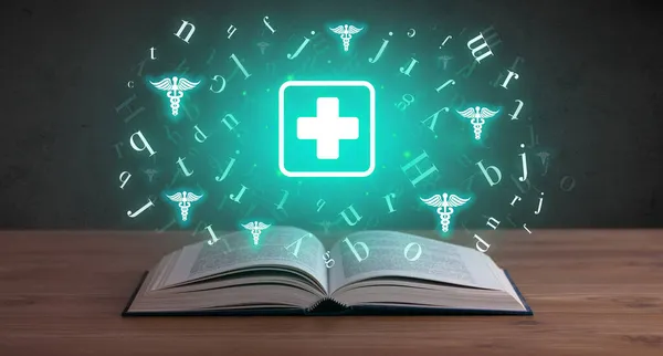 Otwarta książka medyczna z ikonami zdrowia powyżej — Zdjęcie stockowe