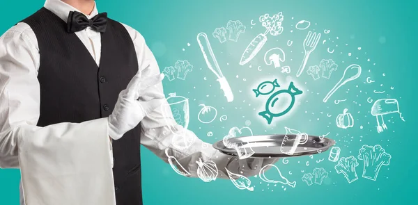 Waiter holding silver tray with food icons above — Stock Photo, Image