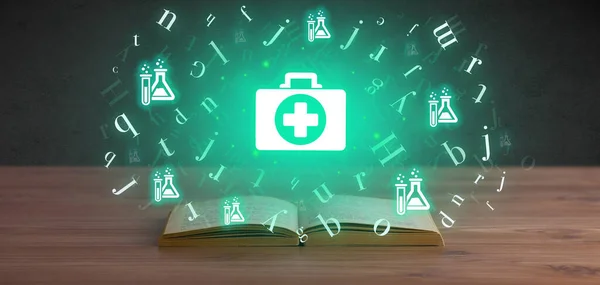 Otwarta książka medyczna z ikonami zdrowia powyżej — Zdjęcie stockowe