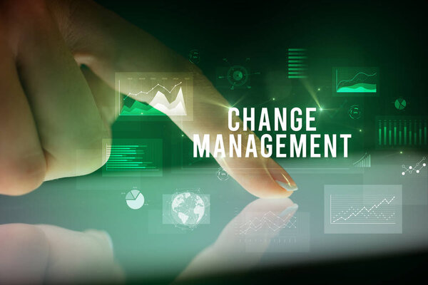 Finger touching tablet with business graphs and icons concept