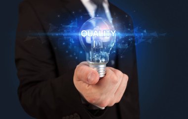 Elinde ampul tutan bir iş adamı.