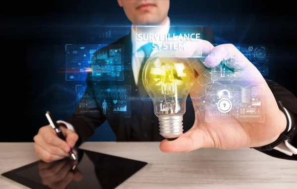 Businessman holding a light bulb, online security concept — Stock Photo, Image