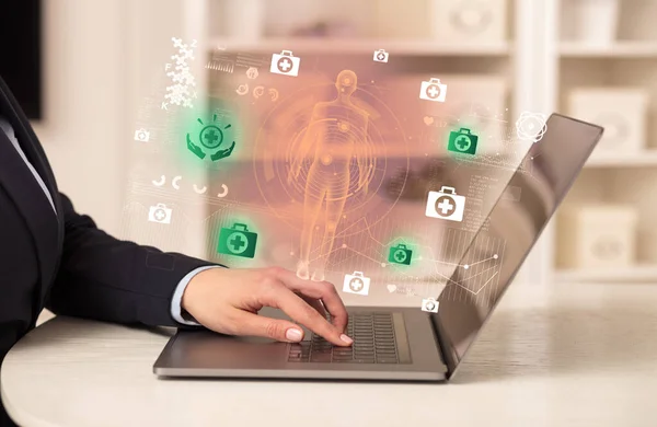 Doctor working on laptop with healthcare concept — Stock Photo, Image