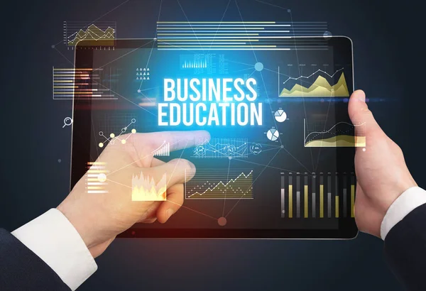 Close-up of hands holding tablet with business inscription — Stock Photo, Image