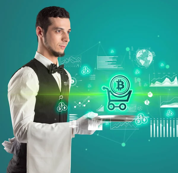 Handsome young waiter in tuxedo holding currency icons on tray — Stock Photo, Image