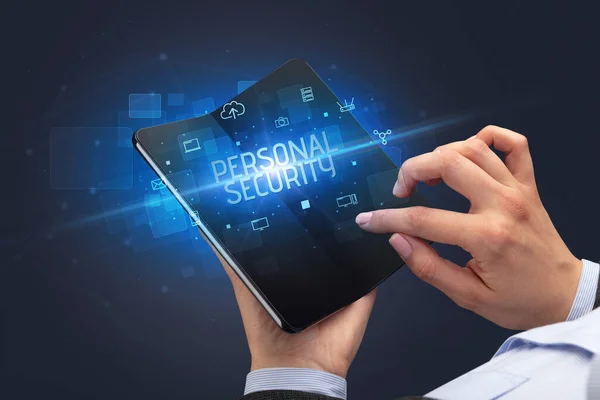 Businessman holding a foldable smartphone, security concept — Stock Photo, Image