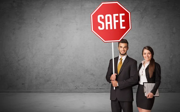 Young business person holding road sign — Stock Photo, Image