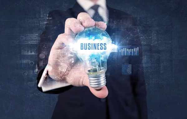 Businessman holding a light bulb, business concept — Stock Photo, Image