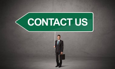 Gündelik trafik levhasındaki genç iş adamı.