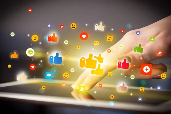 Close-up of a hand using tablet with social media icons — Stock Photo, Image