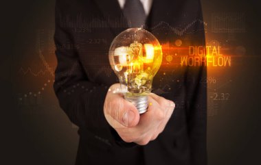 Businessman holding a lightbulb concept