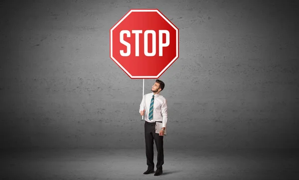 Young business person holding road sign — Stock Photo, Image