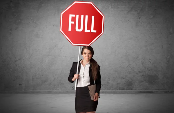 Young business person holding road sign — Stock Photo, Image