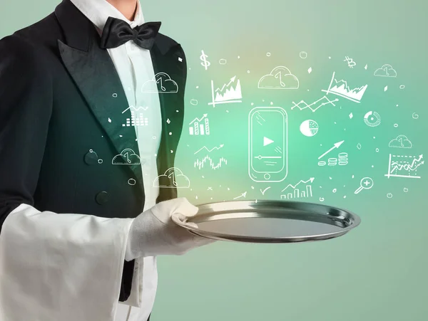 Handsome young waiter in tuxedo holding money icons on tray — Stock Photo, Image