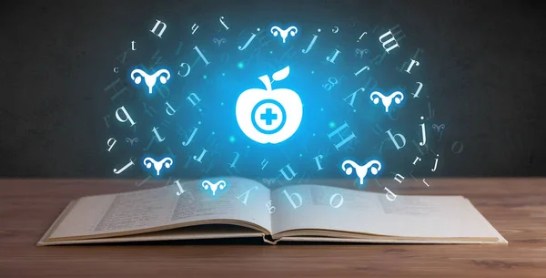 Open medical book with health icons above — Stock Photo, Image