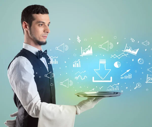 Handsome young waiter in tuxedo holding money icons on tray