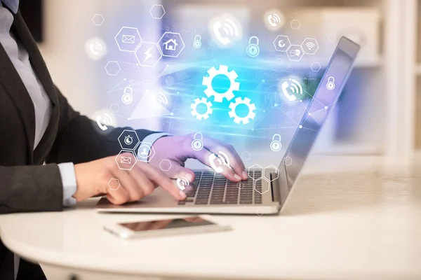 Hands working on laptop with digital icons — Stock Photo, Image