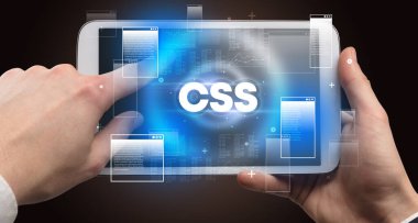 CSS kısaltmalı, modern teknoloji kavramlı el ele tutuşma tabletinin yakın çekimi