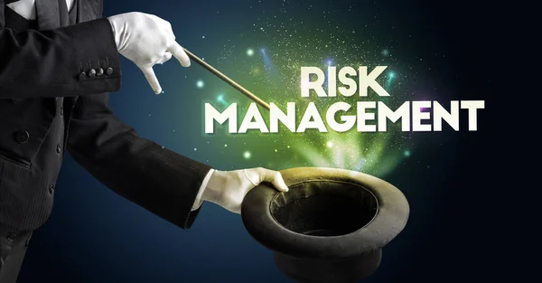 Illusionist is showing magic trick with RISK MANAGEMENT inscription, new business model concept