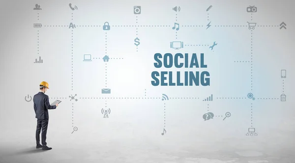 Engineer working on a new social media platform with SOCIAL SELLING inscription concept