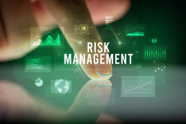 Tablete çizelgeler ve RISK MANAGEMENT yazıtları ile dokunmak, iş konsepti