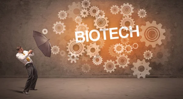 Biznesmen Broniący Się Parasolem Napisem Biotech Koncepcja Technologii — Zdjęcie stockowe