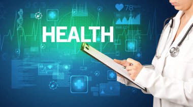 Genç doktor, sağlık sigortası kavramına ve sağlık yazısına sahip notlar yazıyor.