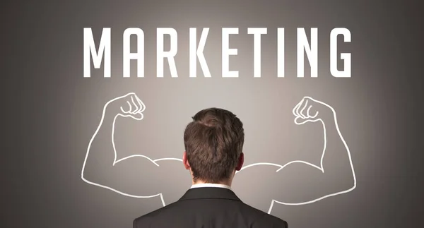 マーケティングの碑文 強力なビジネスコンセプトを持つビジネスマンの背面ビュー — ストック写真