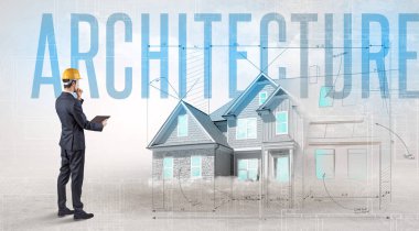 ARCHITECTURE yazıtları ve ev planlama konsepti olan genç bir mühendis elinde