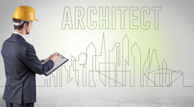 Elinde ARCHITECT yazıtları, mühendisliği ve mimari konsepti olan sağlam şapkalı bir işadamı.