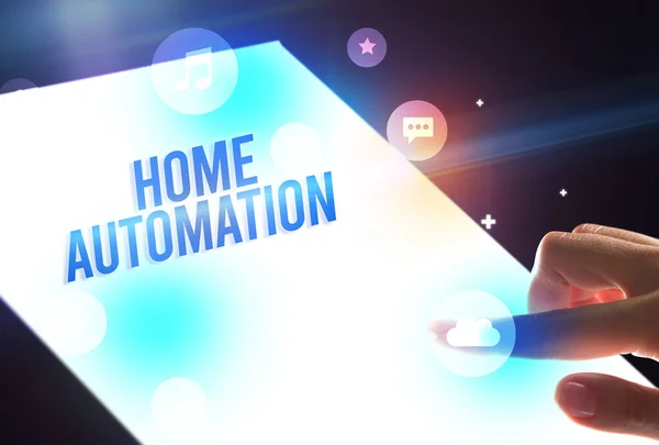 Holding futuristic tablet with HOME AUTOMATION inscription, new technology concept
