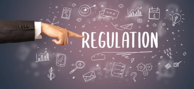 Kesilmiş ellerin yakın çekimi REGULATION yazıtlarına işaret ediyor, modern iş çözümleri kavramı
