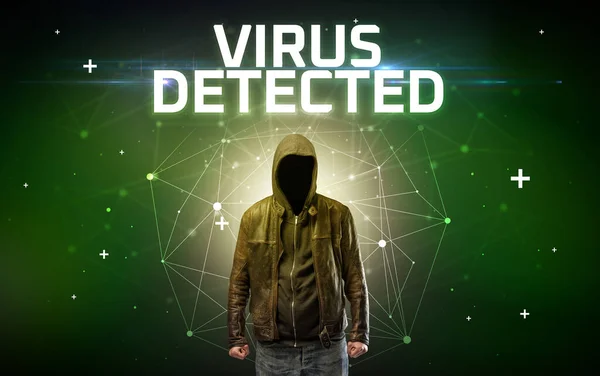 Faceless hacker at work with ROOTKIT VIRUS inscription, Computer