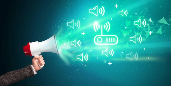 Young person yelling in loudspeaker with wireless technology icon, modern technology concept