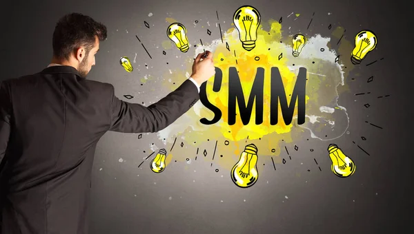 Businessman Drawing Colorful Light Bulb Smm Abbreviation New Technology Idea — Stock Photo, Image