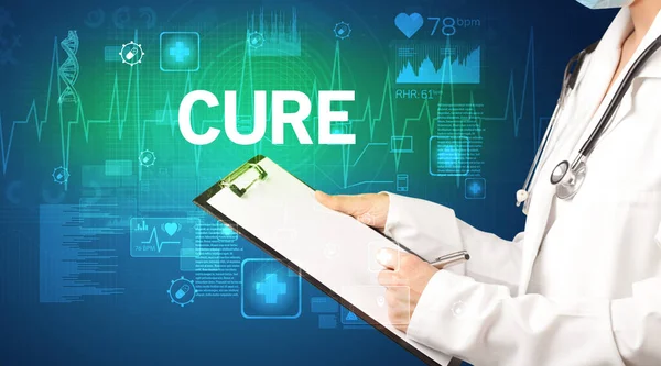 young doctor writing down notes with CURE inscription, healthcare concept