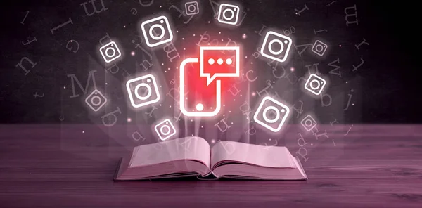 Open book with smartphone chatting icons above, social networking concept