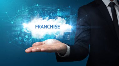FRANCHISE yazıtlarını tutan İşadamı 'nın eli, başarılı iş kavramı