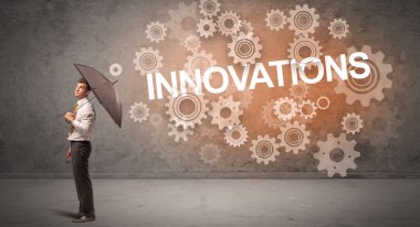 Şemsiyeyle savunma yapan iş adamı INNOVATIONS yazıtları, teknoloji konsepti
